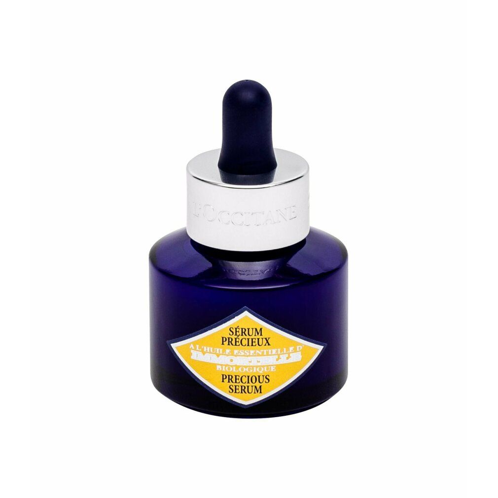 Flacone blu scuro con tappo argentato e pipetta. Etichetta gialla con testo. Nome prodotto: Sérum Précieux.