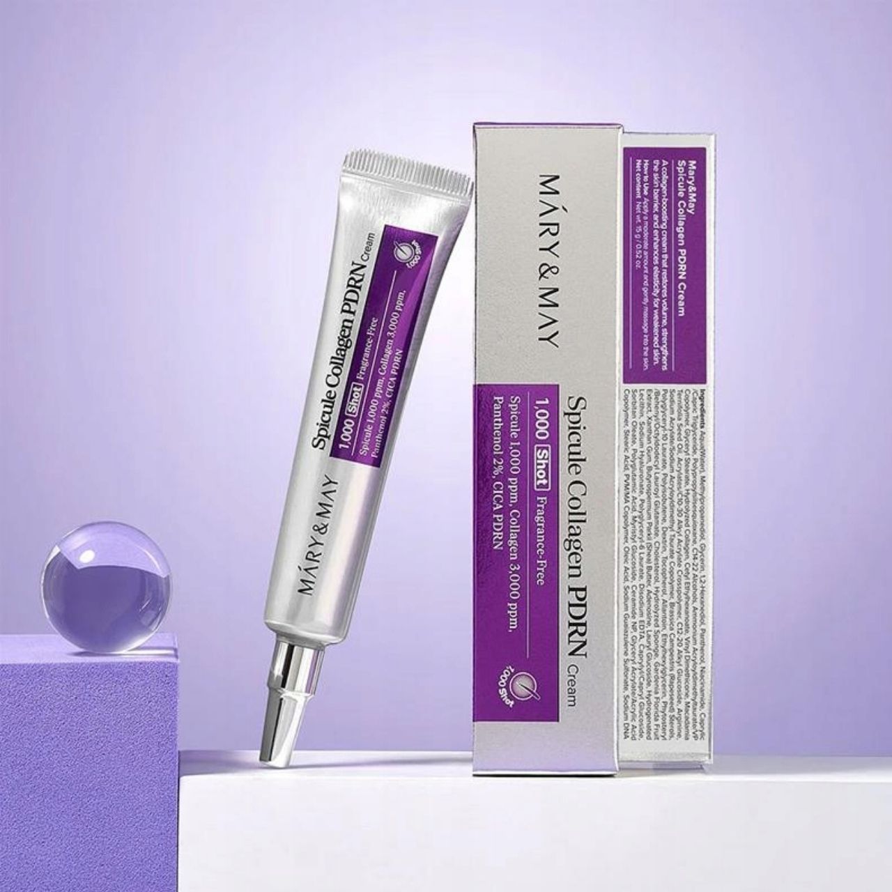 Tubo e confezione in cartone di Mary&May Spicule Collagen PDRN Cream accanto a elementi decorativi.