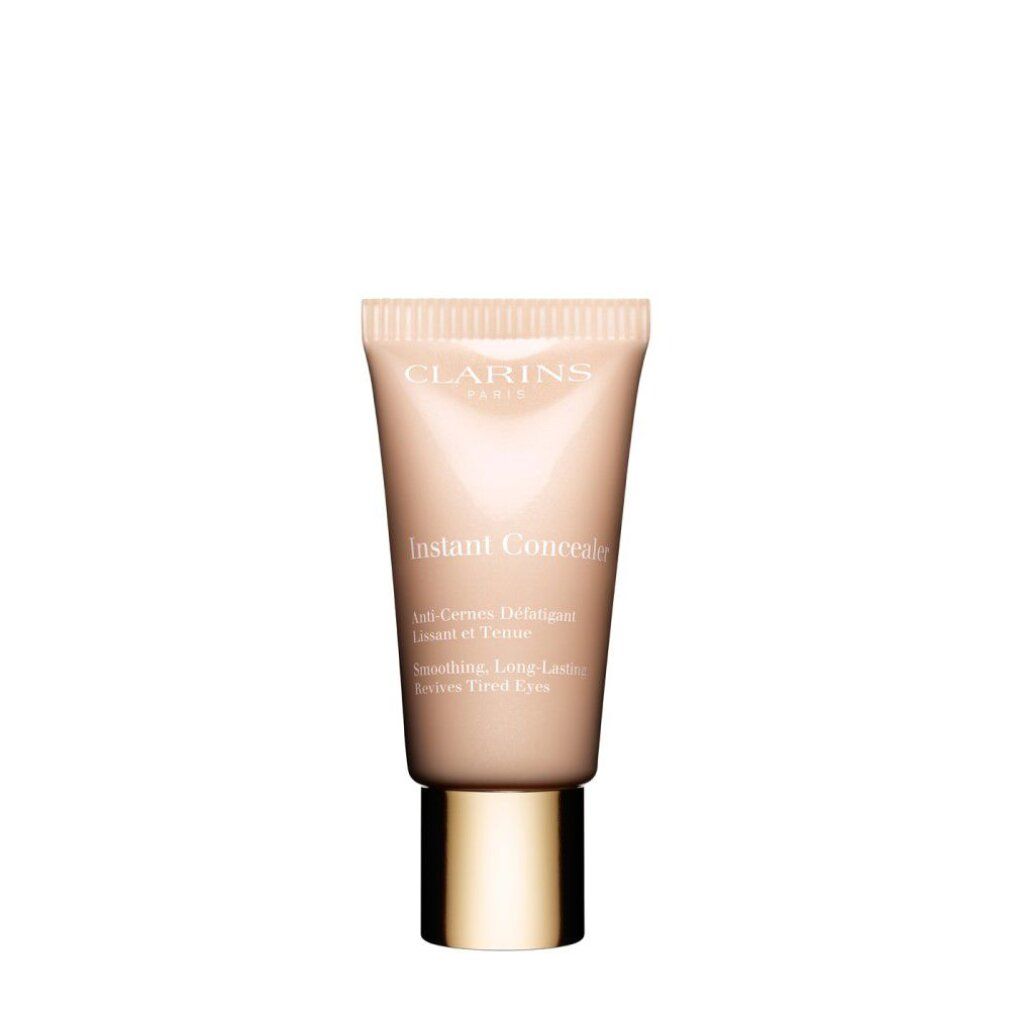 Tubo beige con tappo dorato. Scritta: Clarins, Instant Concealer. Testo: Anti-Cernes Défatigant, Lissant et Teinté, Revives Tired Eyes.