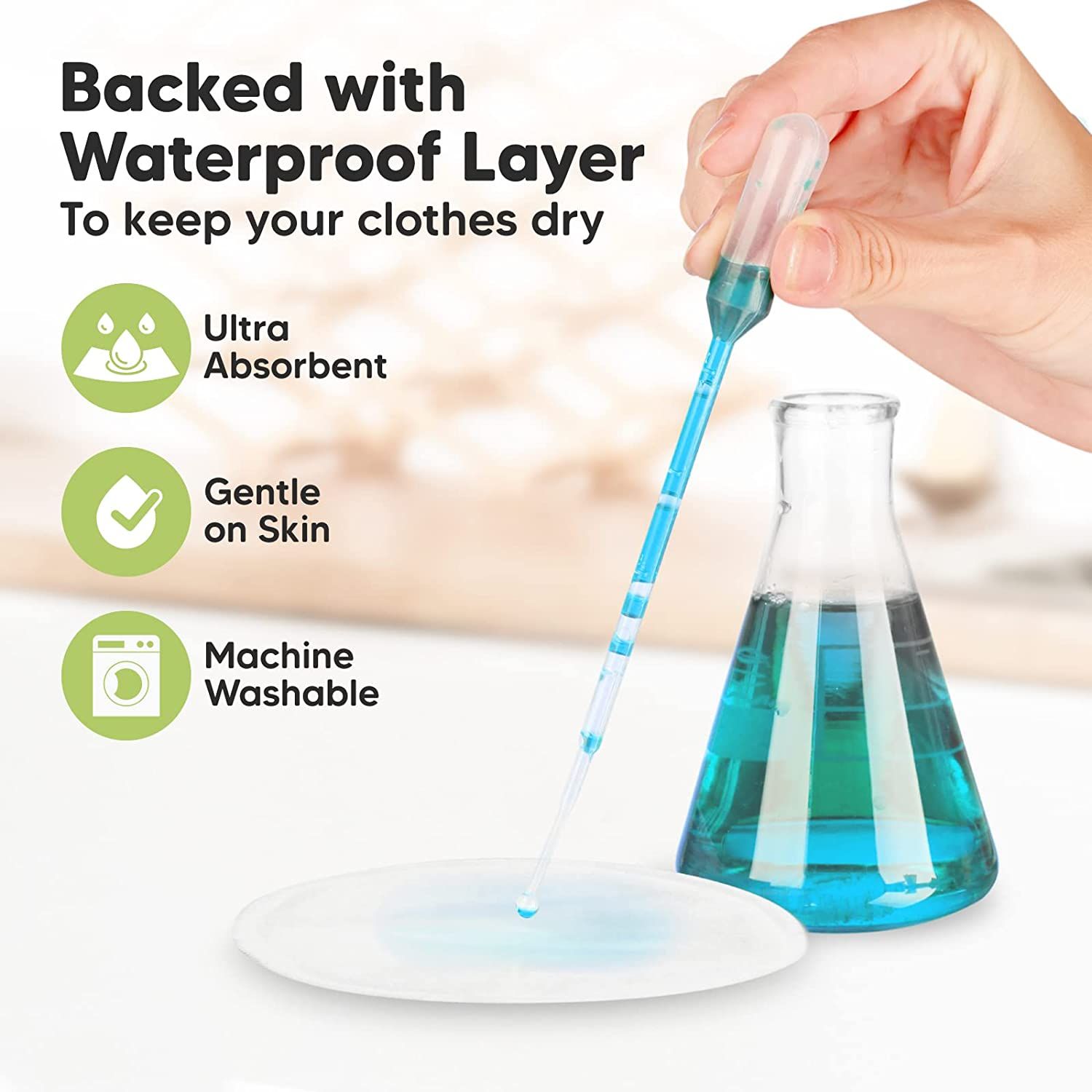 Coppetta assorbilatte con goccia. Scritta: Ultra Absorbent, Gentle on Skin, Machine Washable. Beuta da laboratorio e pipetta.
