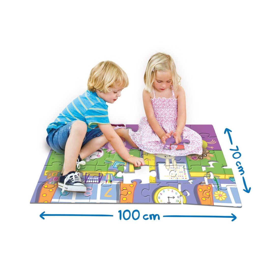 Puzzle da pavimento con motivo Peppa Pig. Due bambini giocano sul puzzle. Dimensioni: 100 cm x 70 cm. Il puzzle mostra una strada con edifici e personaggi.