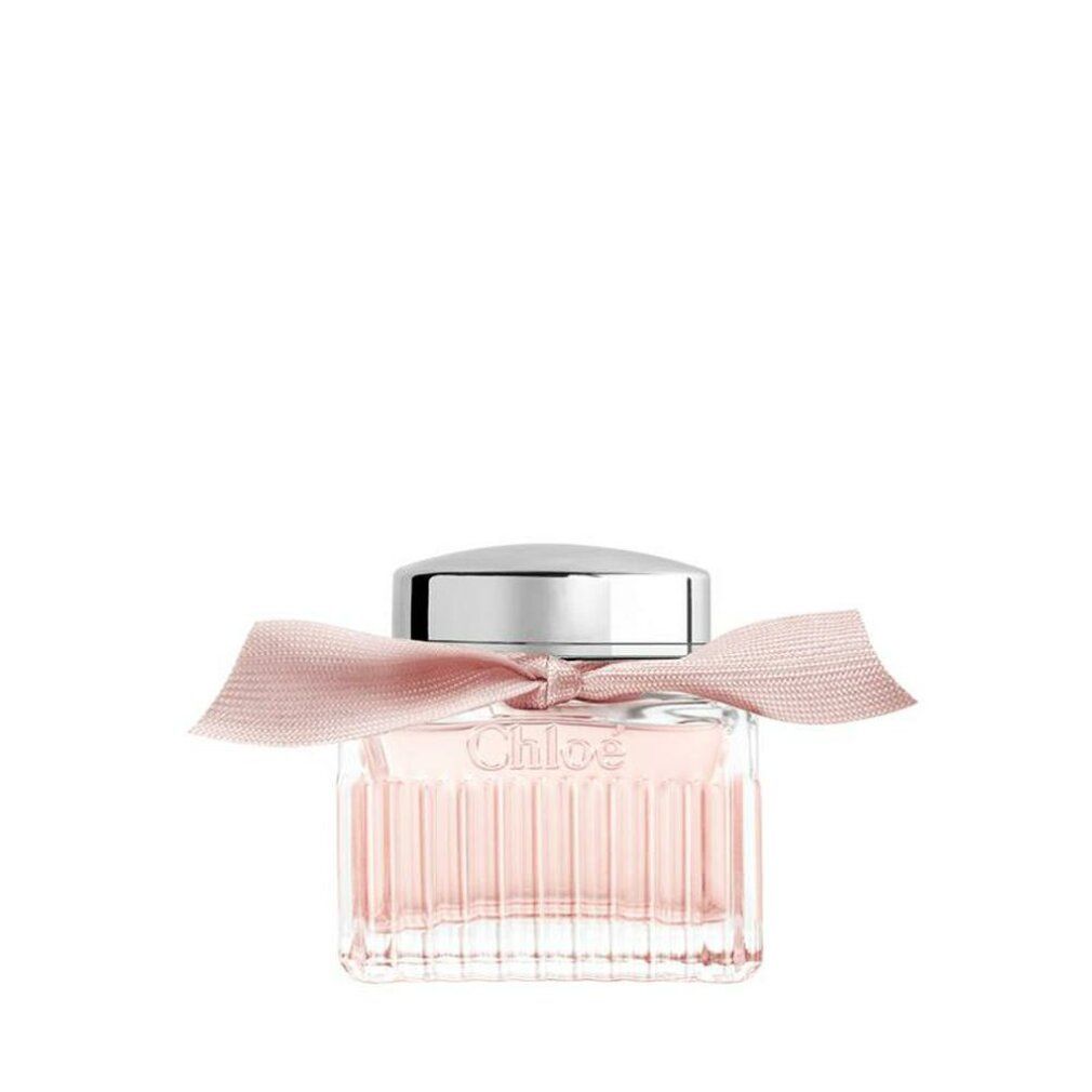 Flacone quadrato in vetro con tappo argentato e fiocco rosa. Il flacone contiene un liquido rosa.