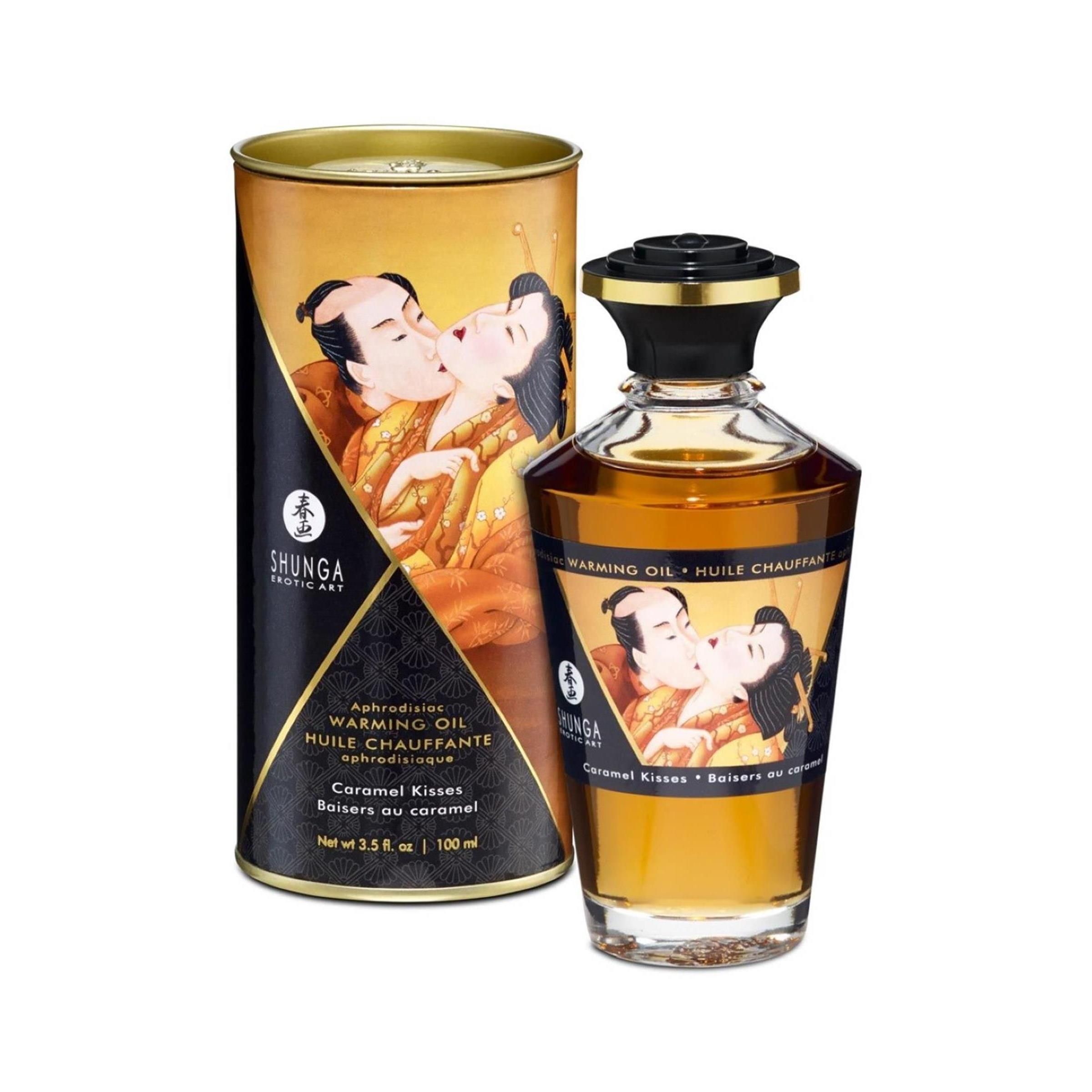 Scatola cilindrica e flacone d'olio. Scatola con illustrazione di coppia che si bacia. Flacone con tappo nero ed etichetta.