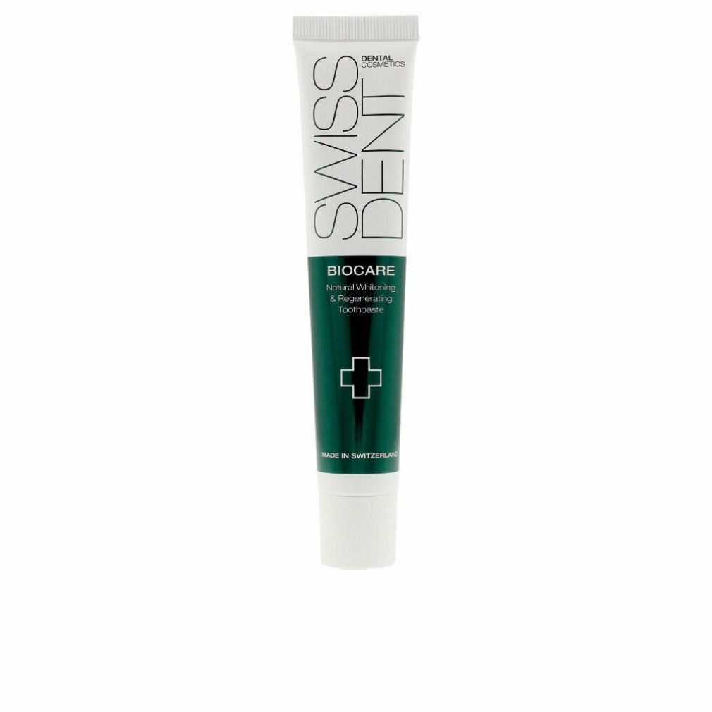 Tubo di dentifricio con banda verde. Scritta Swissdent, Biocare, Natural Whitening & Regenerating Toothpaste. Croce verde.