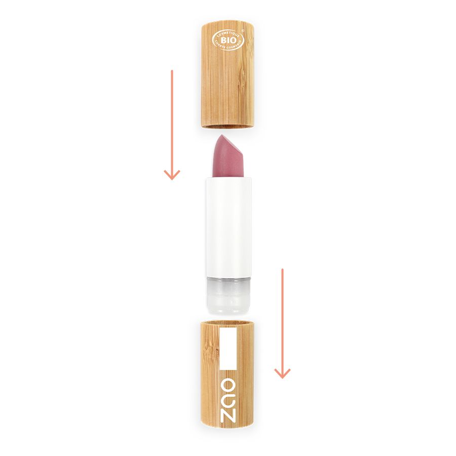 Rossetto in pezzi. Stick rosa, corpo bianco, parti in legno e trasparenti. Frecce che indicano l'assemblaggio.