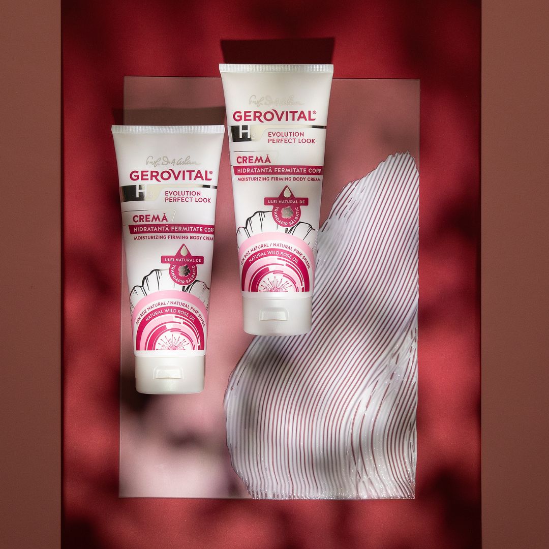 Due tubi di crema Gerovital. Etichette rosa e bianche. Su sfondo rosso con tessuto.