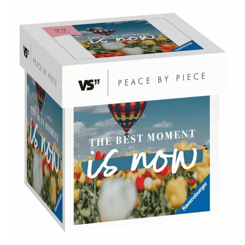 Scatola puzzle con stampa. Motivo: mongolfiere su campo fiorito. Testo: The Best Moment is now. Marca: Ravensburger. 99 pezzi.