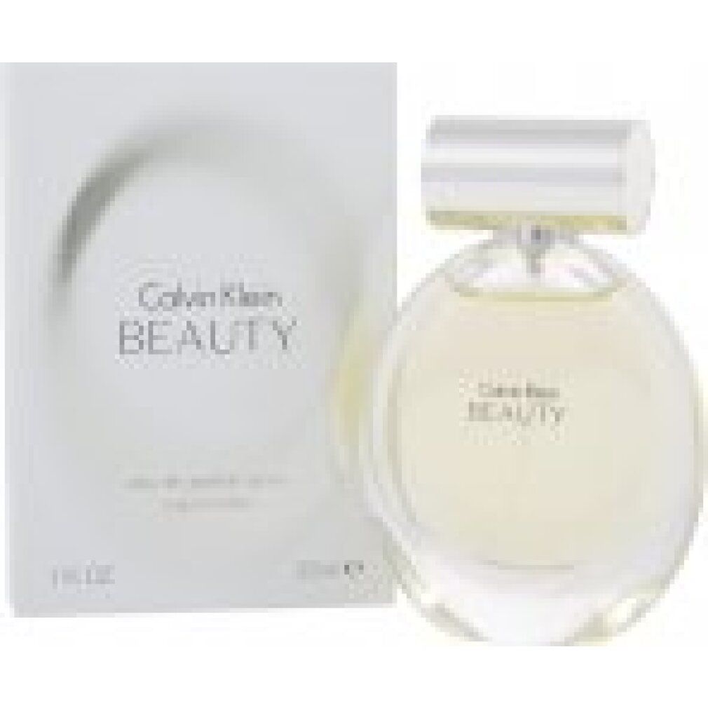 Flacone di profumo e confezione. Flacone rotondo, tappo argentato, liquido giallognolo. Confezione bianca, scritta Calvin Klein BEAUTY.