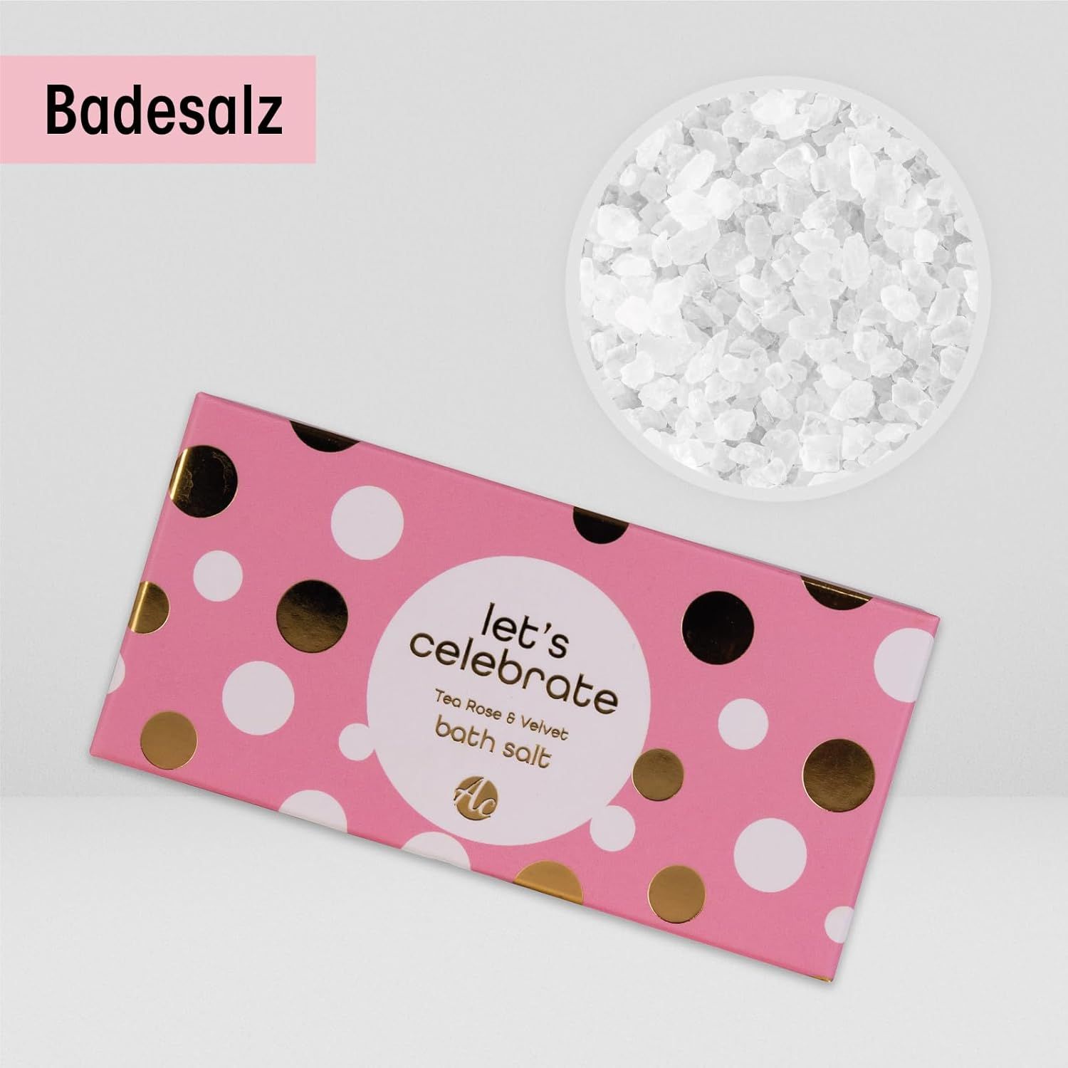 Scatola rosa con pois bianchi e dorati. Scritta: Let's Celebrate. Contiene sali da bagno. Accanto, una ciotola di sali da bagno.