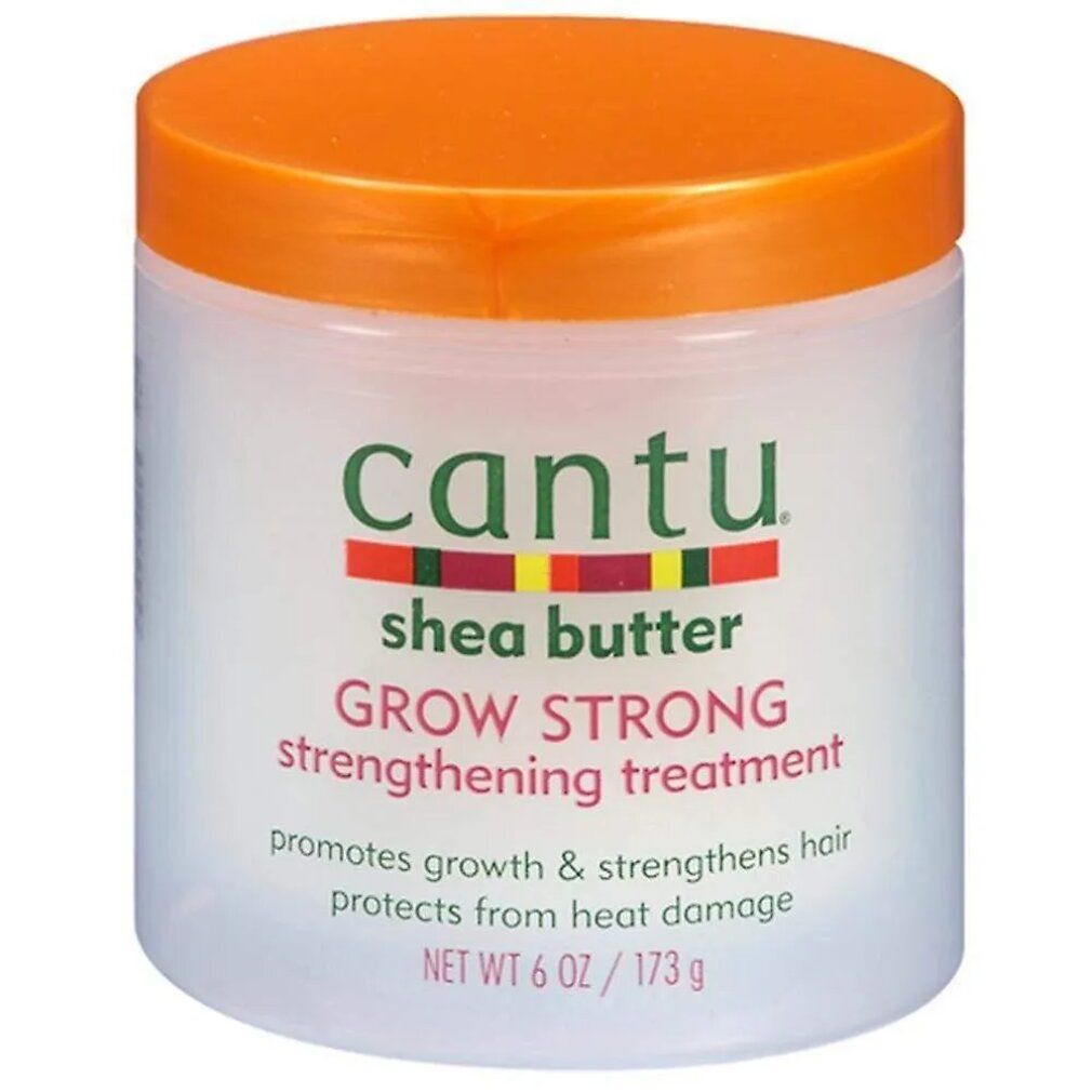 Vaso bianco con coperchio arancione. Scritta: Cantu, Shea Butter, Grow Strong, Strengthening Treatment. Netto 6 OZ / 173 g.