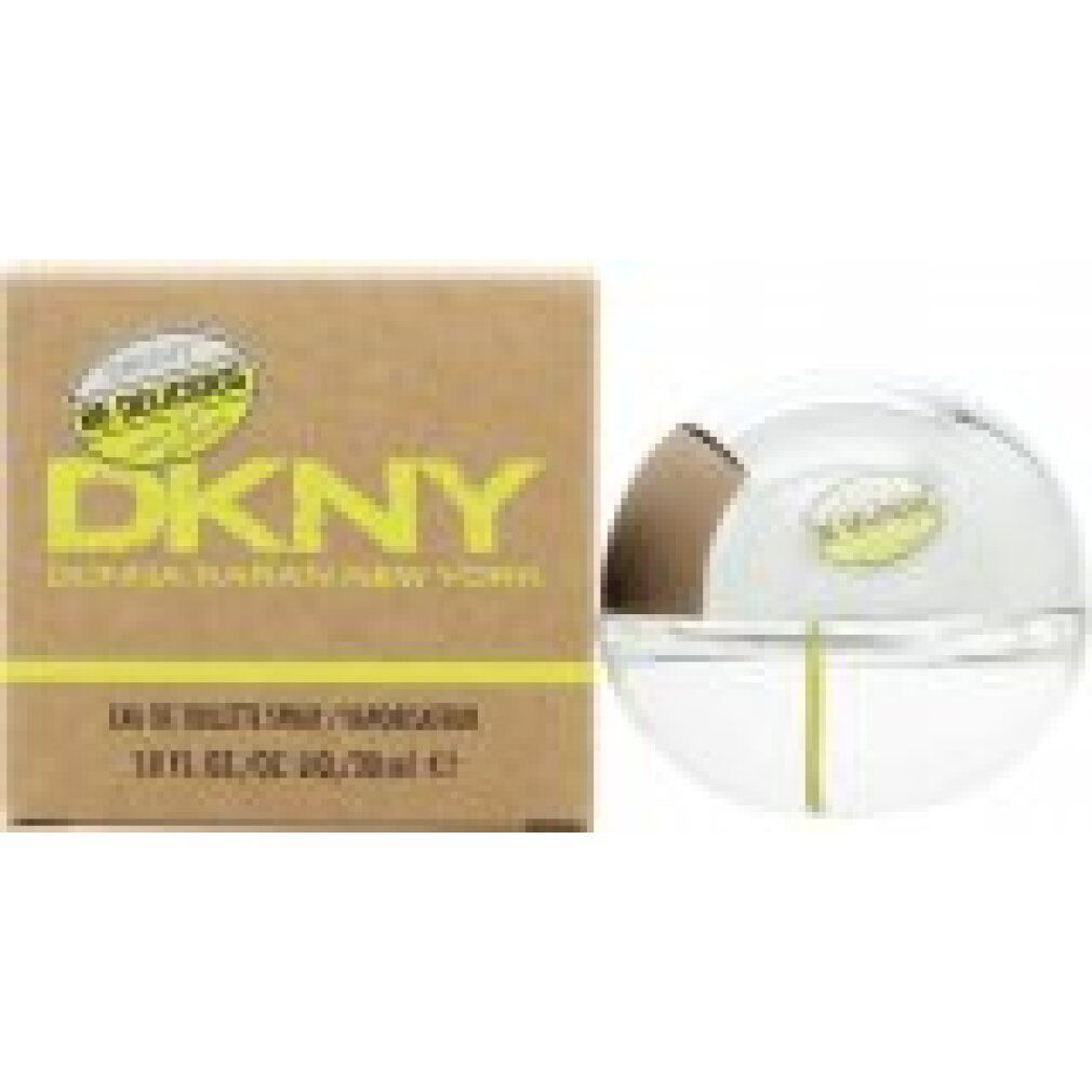 Flacone sferico in vetro con tappo argentato e stelo giallo. Accanto, una scatola marrone con logo DKNY giallo.