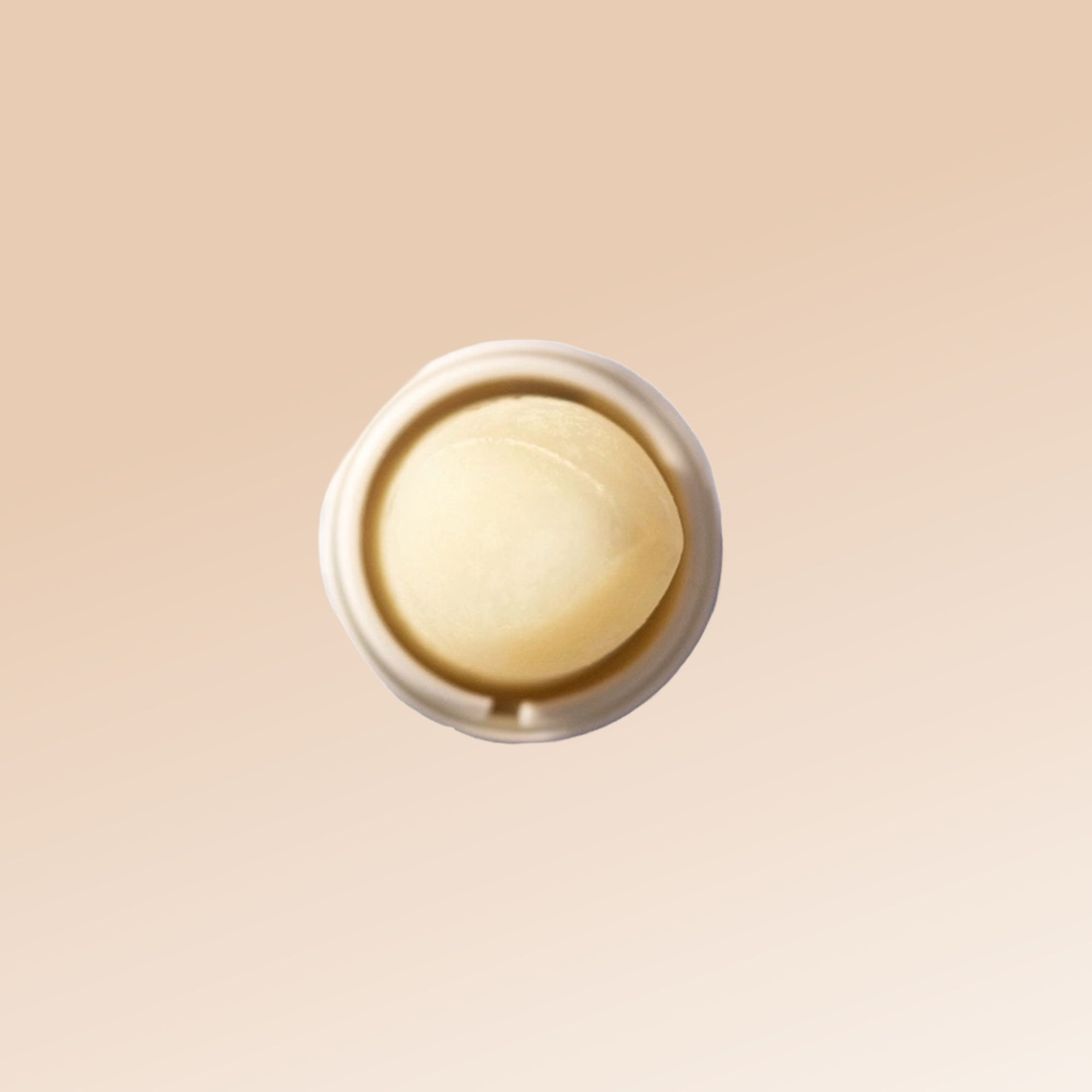 Vista dall'alto di uno stick labbra. Lo stick è bianco, con un cuore giallo.