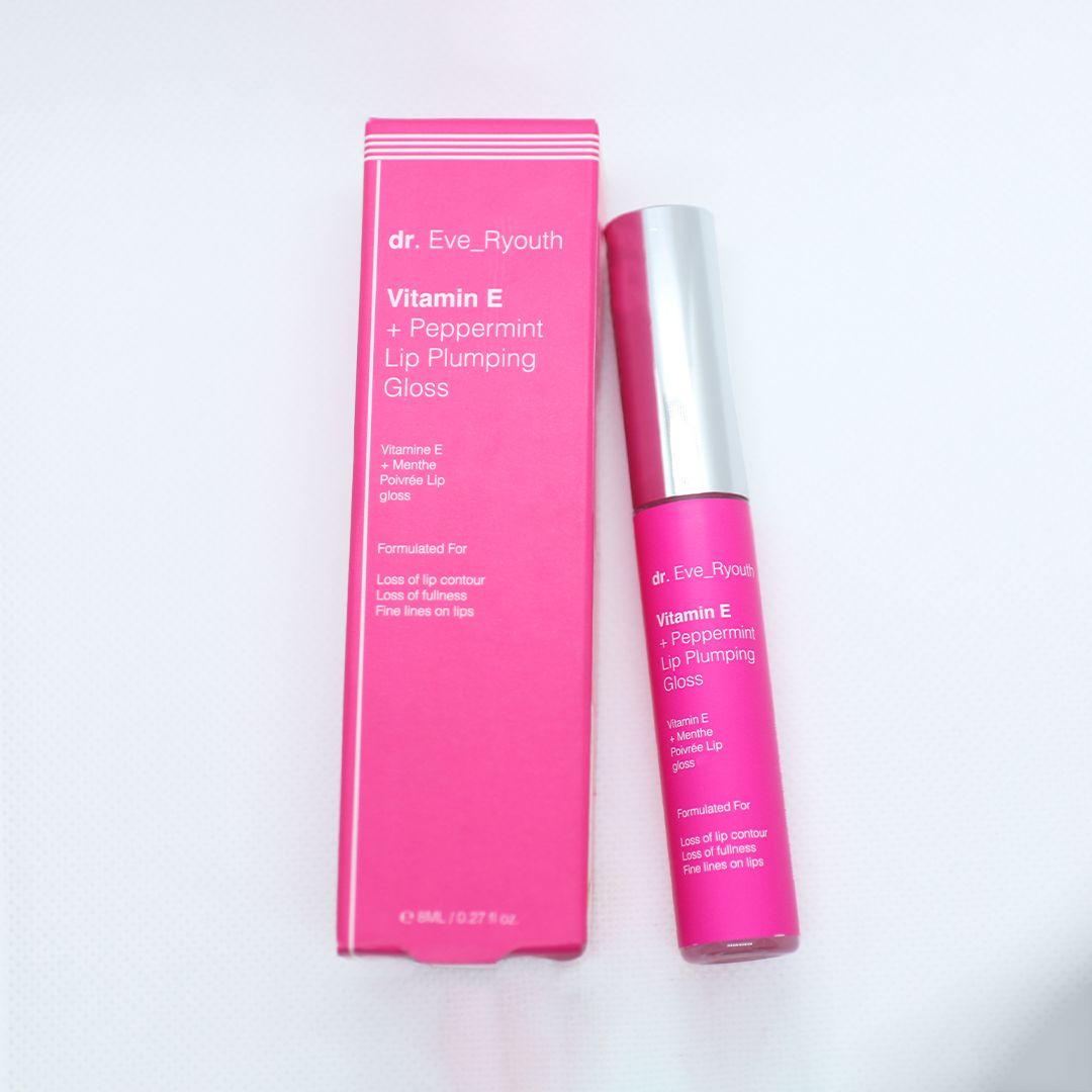 Lucidalabbra rosa e confezione. Scritta: Dr. Eve_Ryouth, Vitamina E + Menta piperita. Prodotto accanto alla confezione.