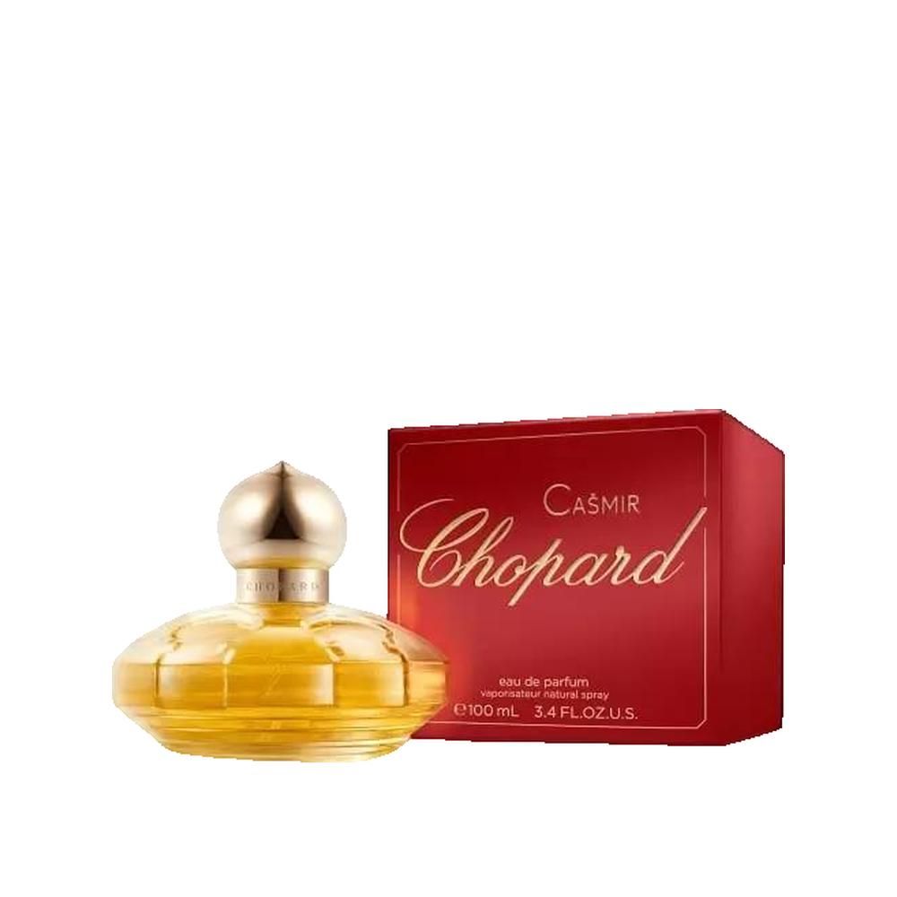 Flacone di profumo giallo con tappo dorato e confezione rossa. Scritta: Casmir Chopard.
