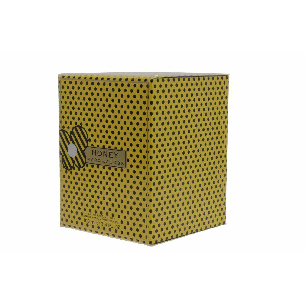 Scatola gialla a pois neri. Scritta "HONEY" e "MARC JACOBS".