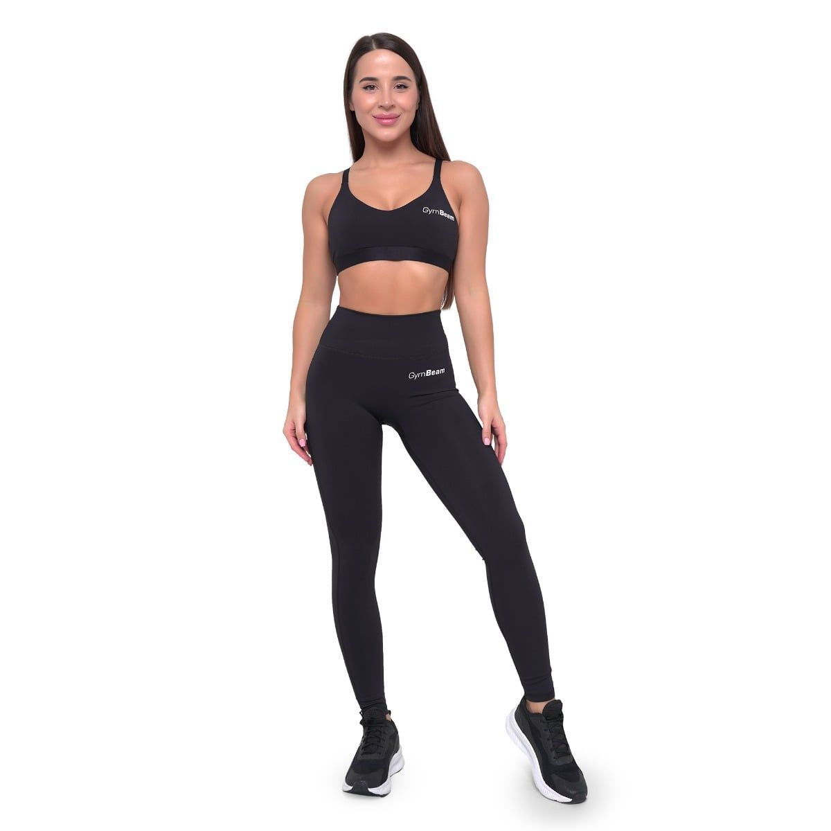 Donna con reggiseno sportivo nero e leggings GymBeam a vita alta.