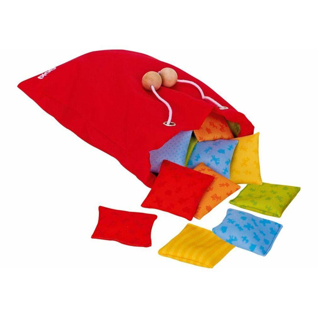 Sacco rosso con coulisse pieno di cuscini quadrati colorati. Alcuni cuscini sono sparsi.