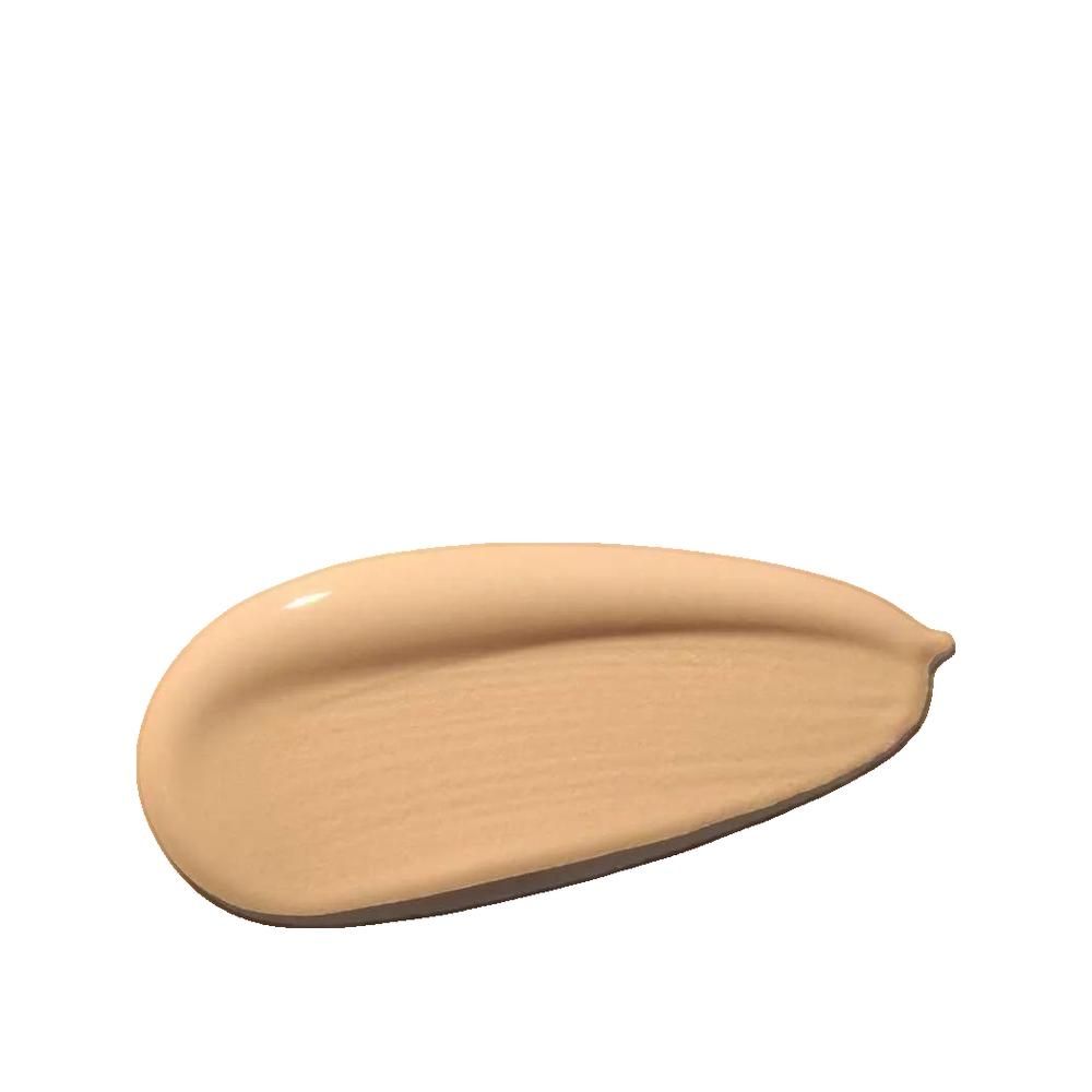 Traccia di fondotinta beige su sfondo bianco. A forma di goccia, lucida.