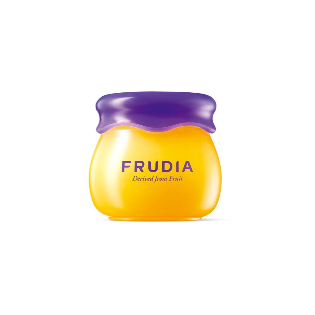 Balsamo labbra Frudia, giallo, in vasetto con coperchio viola. Scritta 'FRUDIA' e 'Derived from Fruit'.