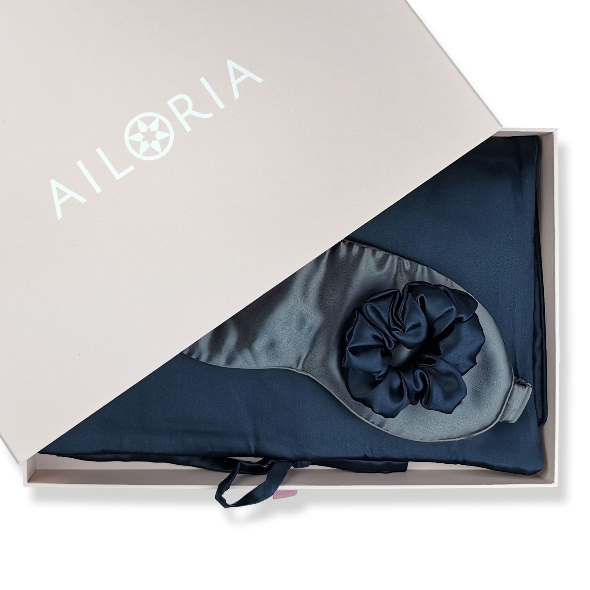 Scatola regalo AILORIA con borsa blu scuro, maschera notte grigia e scrunchie nero.