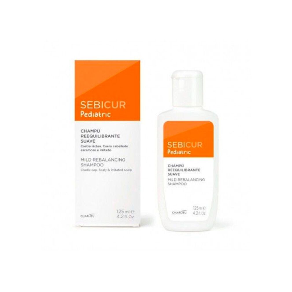 Flacone e scatola bianchi con etichetta arancione. Scritta: Sebicur Pediatric, Champú Reequilibrante Suave, Mild Rebalancing Shampoo.