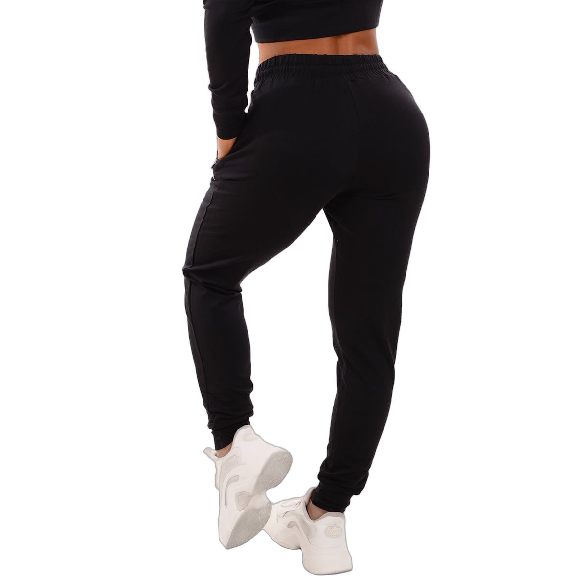 Vista posteriore di pantaloni da jogging neri da donna con coulisse e tasche con zip.