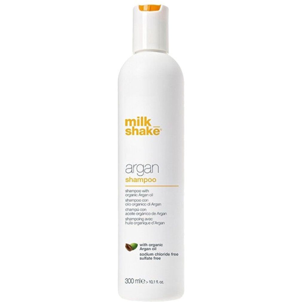 Flacone bianco con stampa gialla. Scritta: milk_shake Argan Shampoo. Contiene olio di argan. 300 ml.