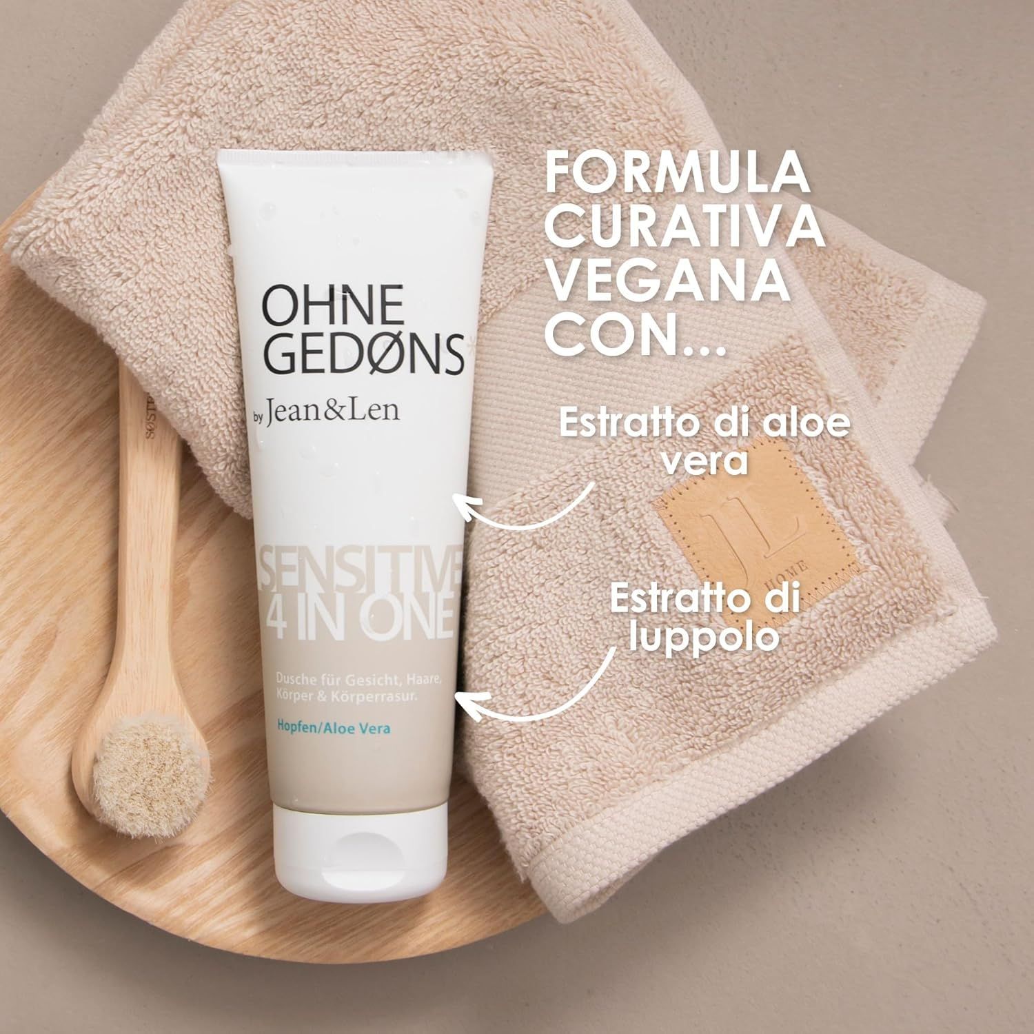Tubo OHNE GEDØNS by Jean & Len, Sensitive 4in1, accanto ad asciugamano, spazzola e aloe vera.