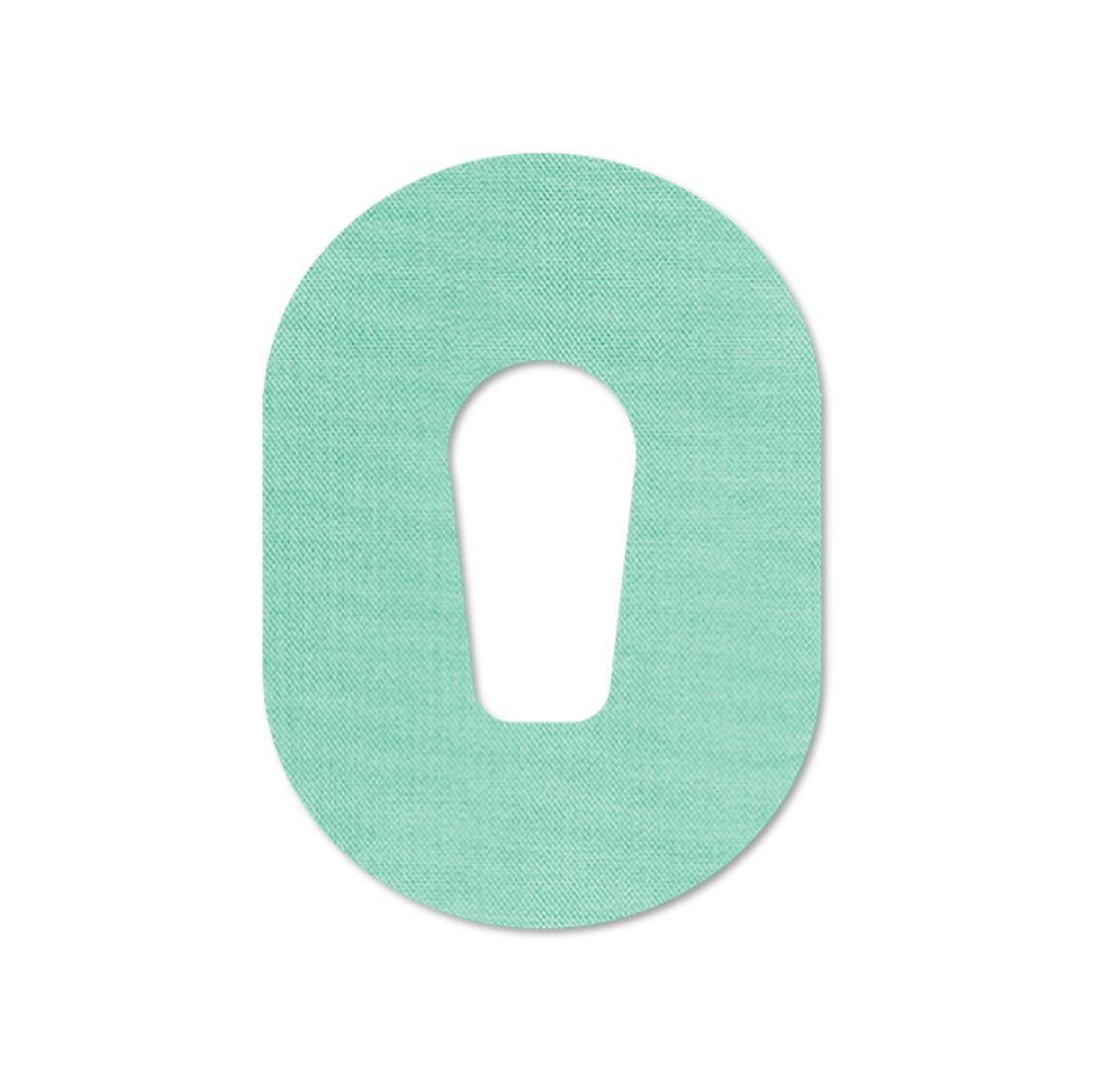 Cerotto ovale menta con intaglio. Superficie tessile.