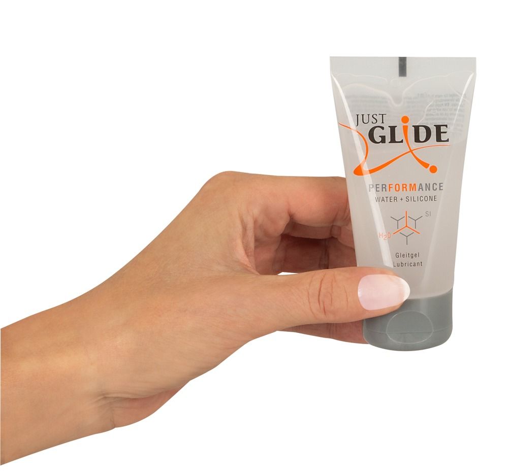 Mano che tiene un tubo di lubrificante Just Glide Performance, Acqua + Silicone.