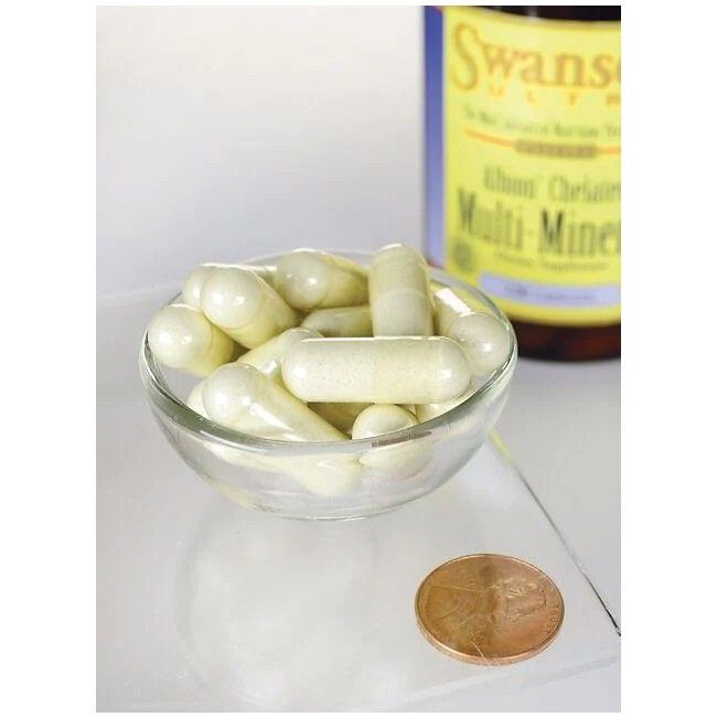 Ciotola di vetro trasparente con capsule. Sullo sfondo, flacone SWANSON Albion Chelat-Multimineral con ferro. Moneta accanto.