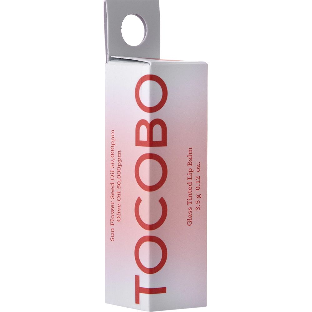 Confezione di cartone con scritta rossa TOCOBO. Testo: Glass Tinted Lip Balm, 3,5 g 0,12 oz. Scritta: Sun Flower Seed Oil 50.000 ppm, Olive Oil 50.000 ppm.