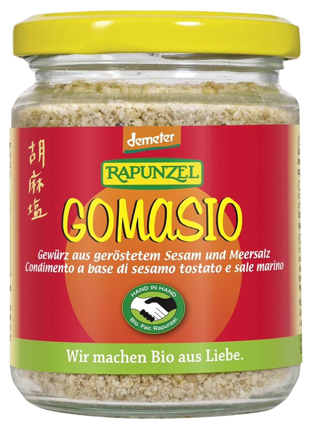 Gomasio Rapunzel, condimento di sesamo tostato e sale marino, in un barattolo di vetro con coperchio giallo.