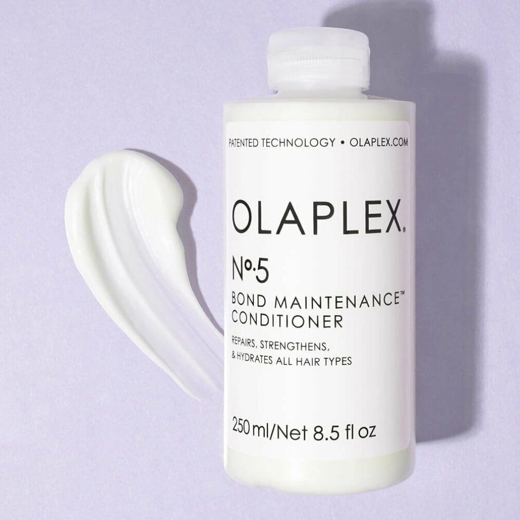 Flacone bianco Olaplex Nº5 Bond Maintenance Conditioner con sostanza cremosa accanto. Contiene 250 ml/8,5 fl oz. Ripara, rinforza e idrata.