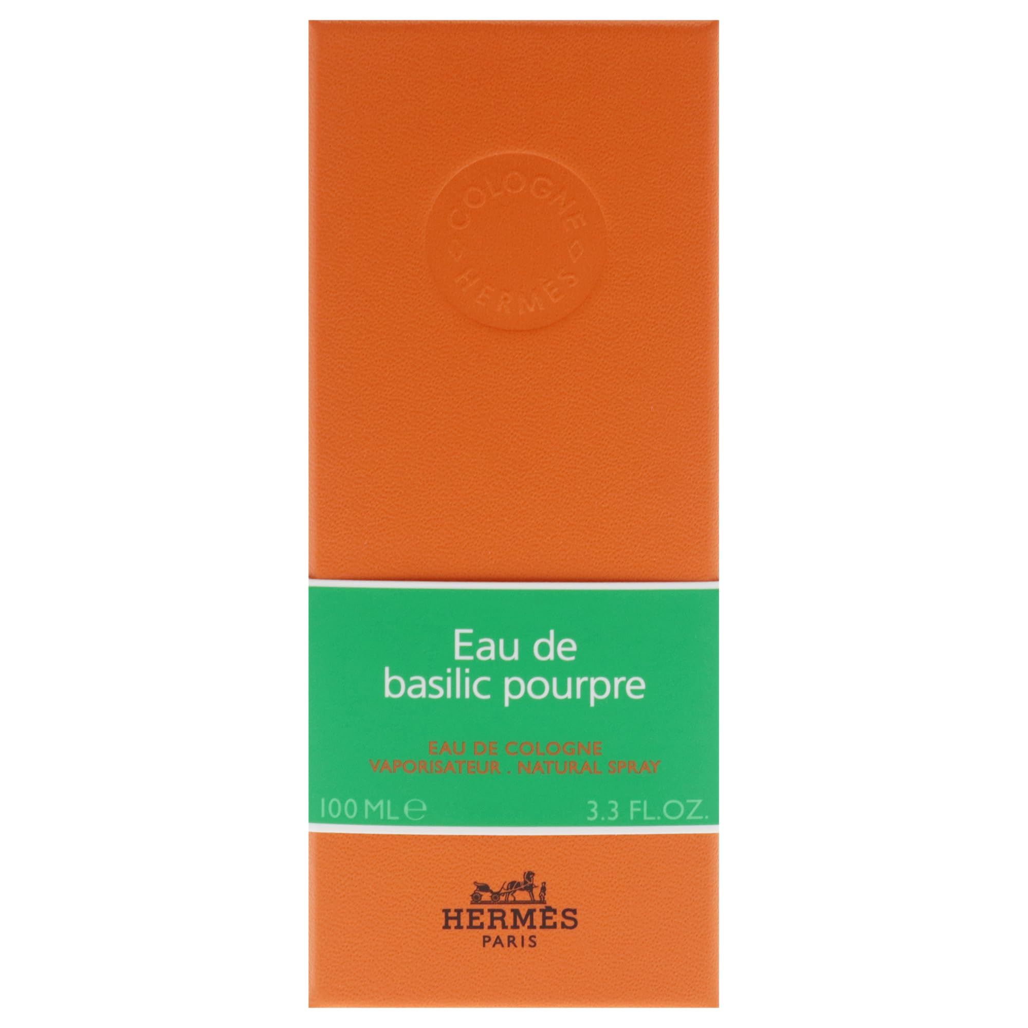Confezione arancione con fascia verde. Scritta: Eau de basilic pourpre, Hermès.