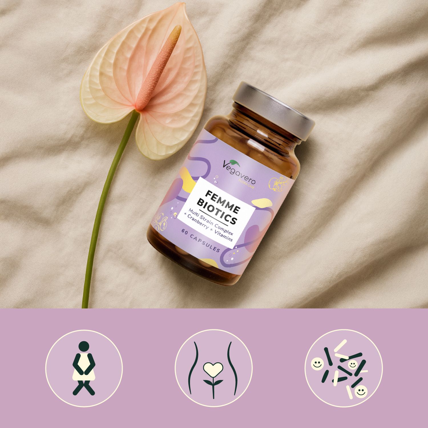 Flacone marrone FEMME BIOTICS accanto a un fiore. Su tessuto beige. Tre icone in basso.