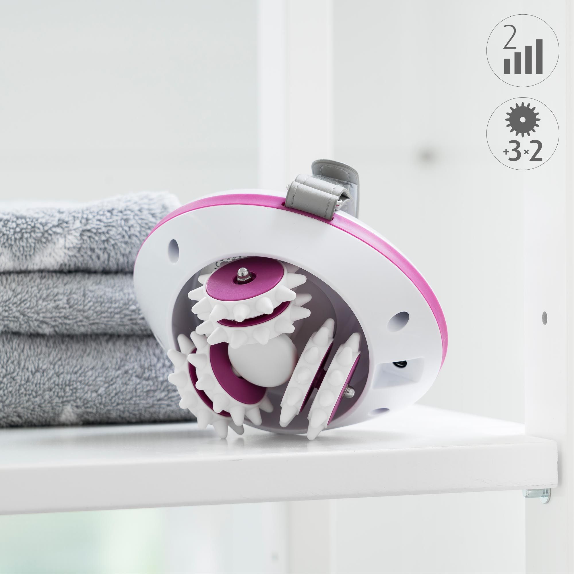Massaggiatore con ingranaggi rosa e corpo bianco. Cinturino grigio. Scritta: 3-2.