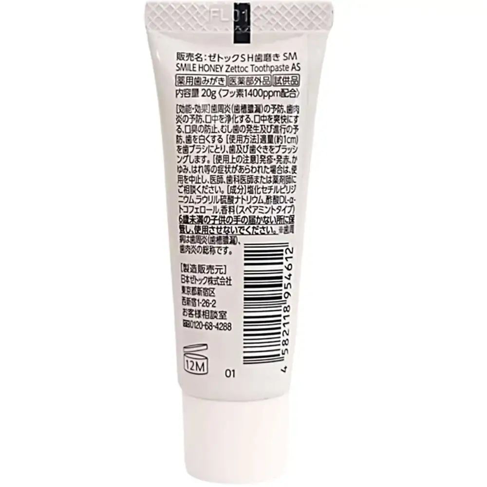 Retro di un tubetto di dentifricio. Testo in giapponese. Tubo bianco, testo nero.
