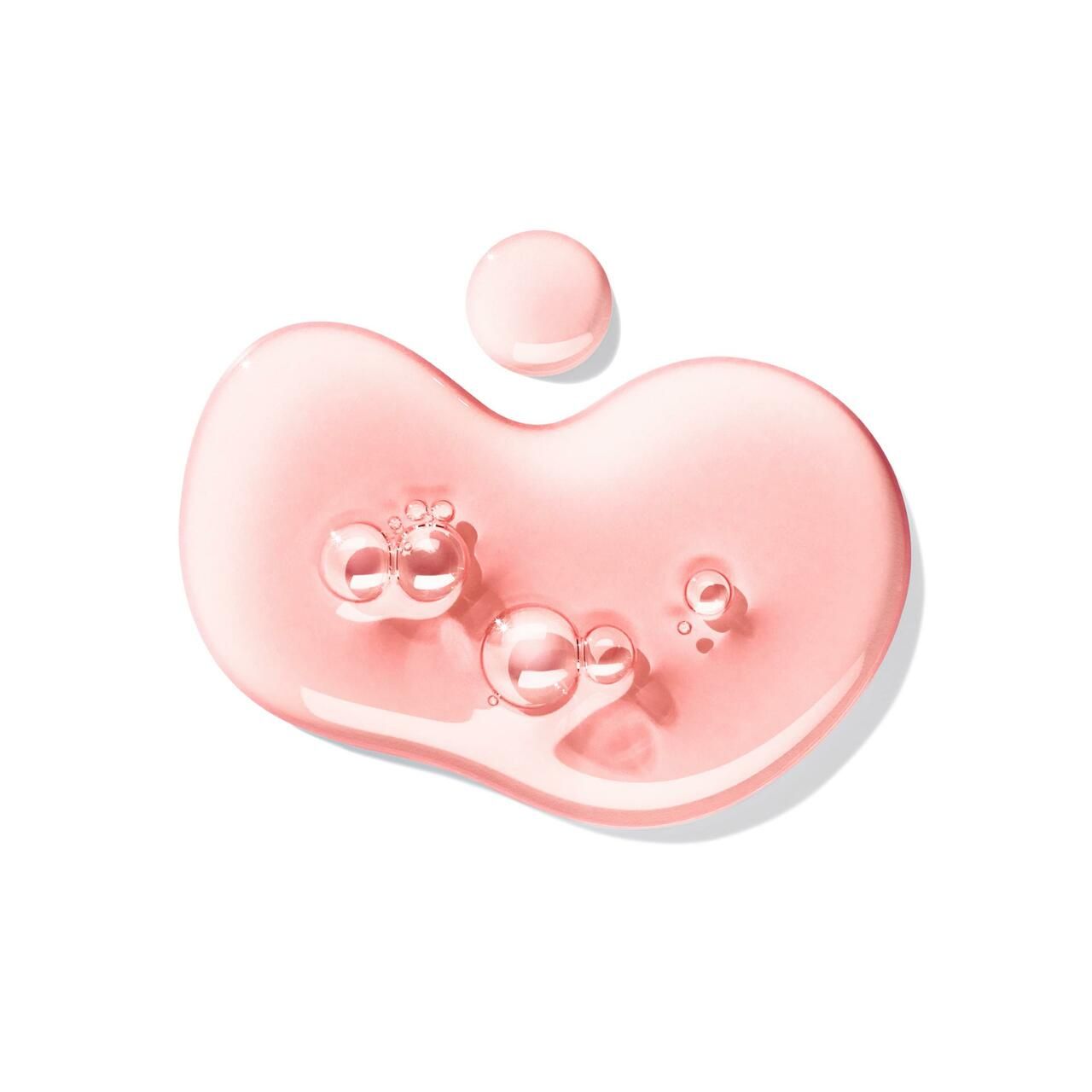 Gocce di liquido rosa con bolle su sfondo bianco.