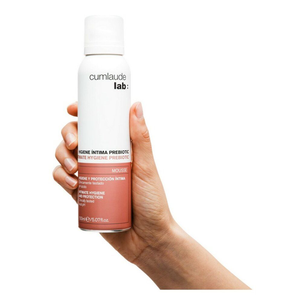 Flacone bianco-rosa tenuto in mano. Scritta: cumlaude lab:. Testo: Intimate Hygiene Prebiotic Mousse. 150ml.