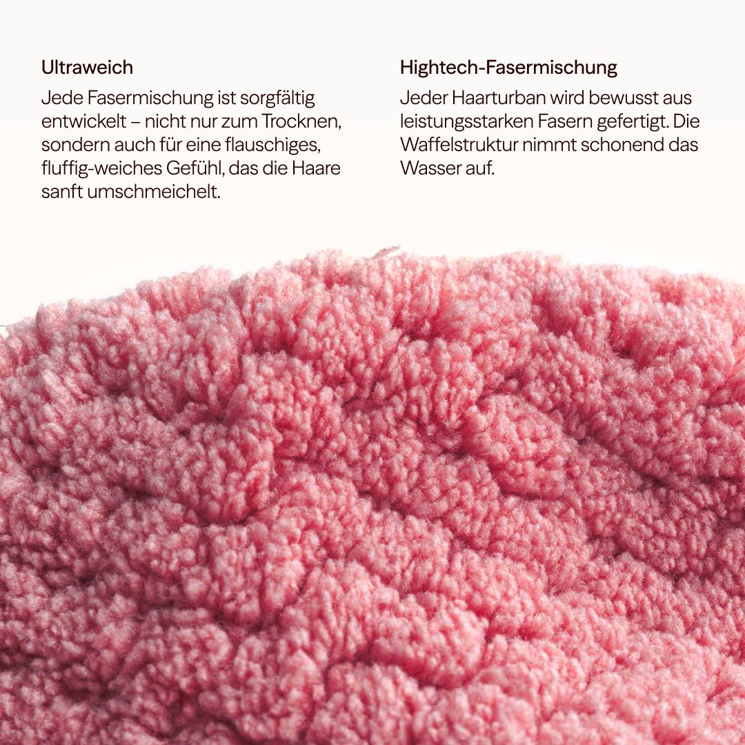 Primo piano del tessuto rosa del turbante per capelli a nido d'ape. Il testo descrive la miscela di fibre high-tech ultra morbida.