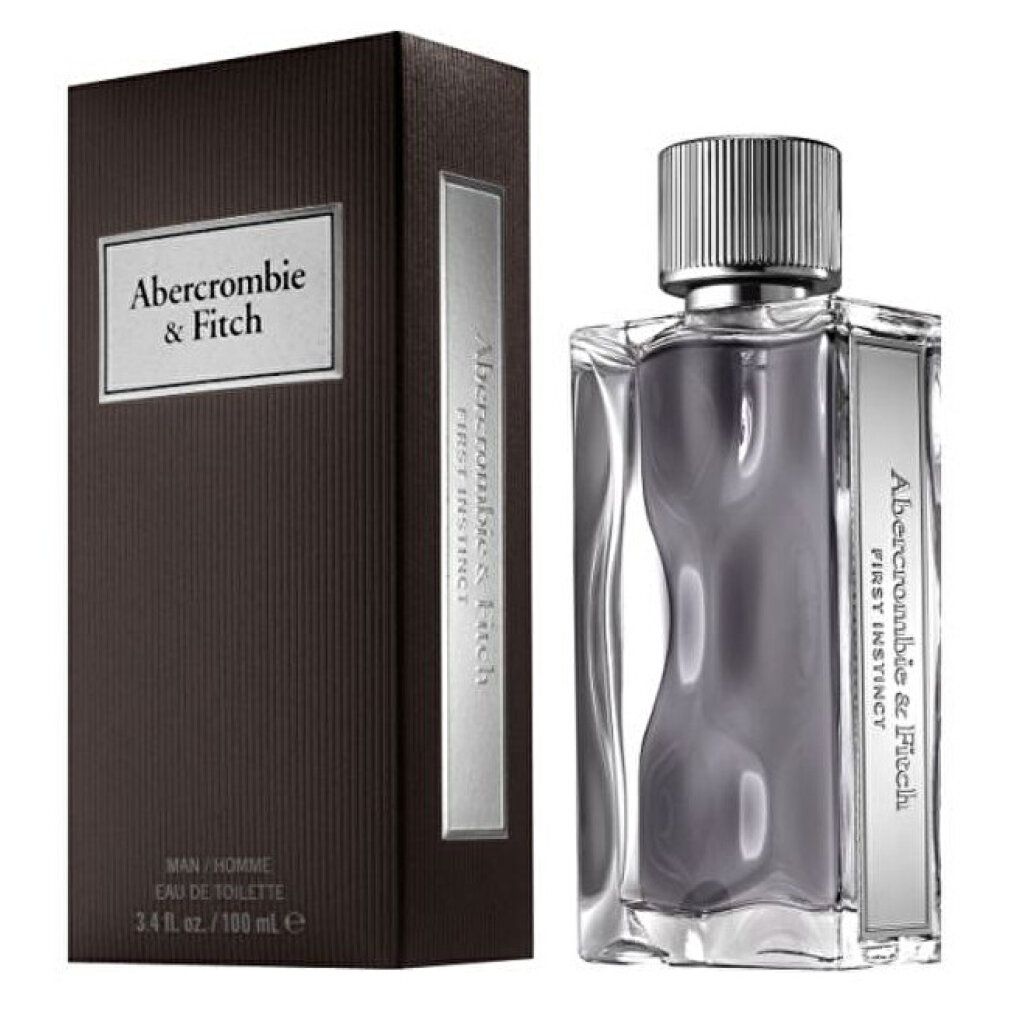Flacone di profumo e scatola marrone. Flacone con tappo argentato. Scritta "Abercrombie & Fitch First Instinct". "Eau de Toilette".