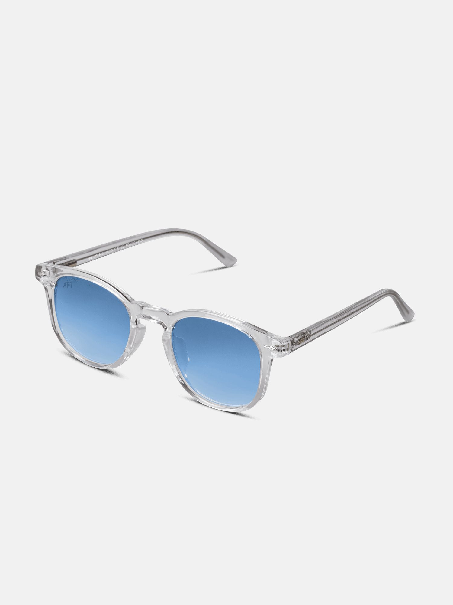 Occhiali da sole Prismalith Indigo Blue. Montatura trasparente, lenti blu. Logo XFT sulla stanghetta.