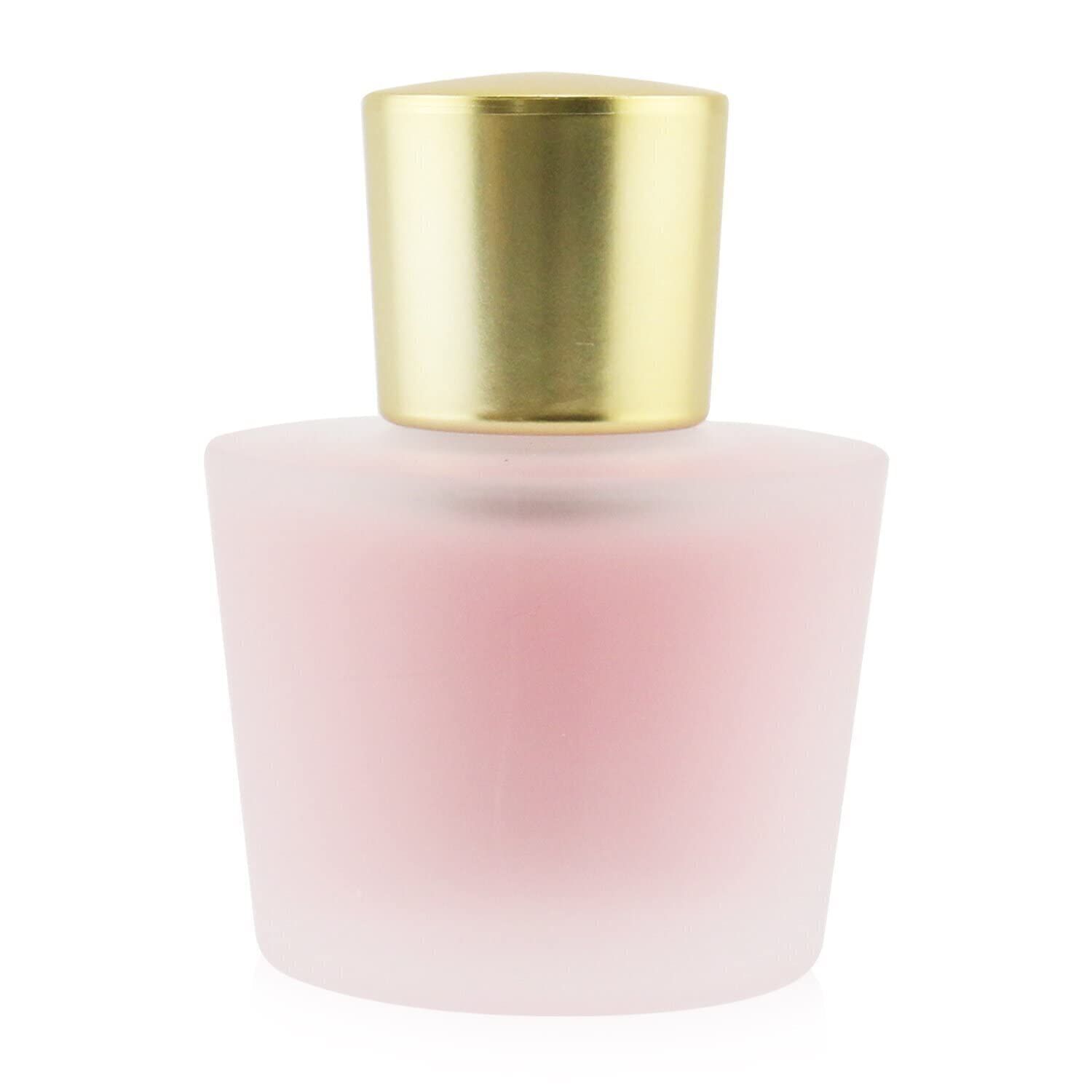 Flacone rosa opaco con tappo dorato. Forma arrotondata.