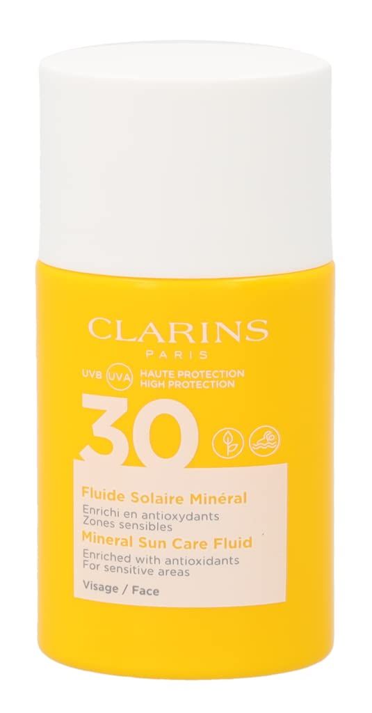 Flacone giallo con tappo bianco. Scritta: Clarins, 30, Fluide Solaire Minéral, Mineral Sun Care Fluid. Per pelli sensibili.