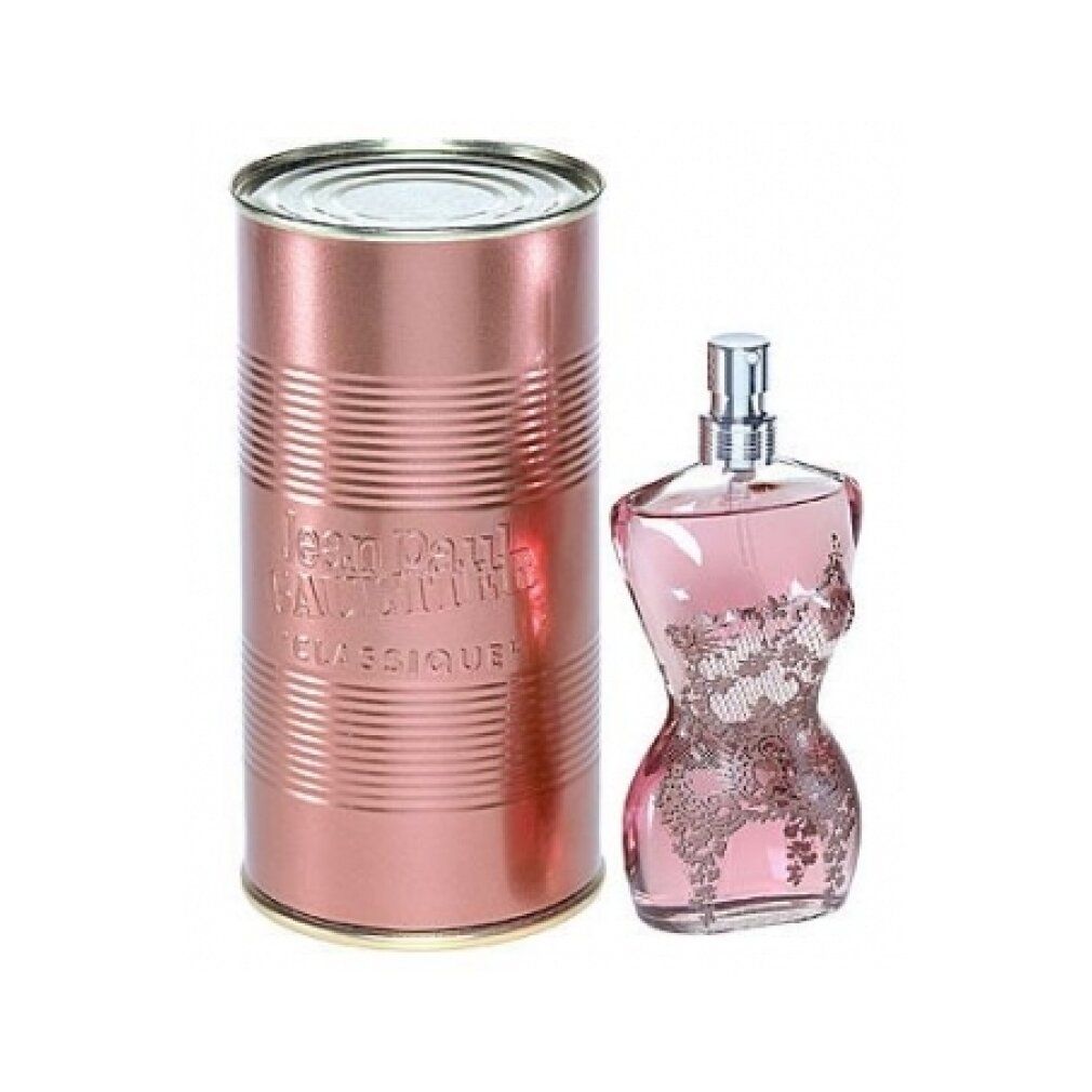 Flacone di profumo a forma di corpo femminile, rosa, con decorazione in pizzo. Accanto, un barattolo cilindrico con inciso "Jean Paul Gaultier Classique".