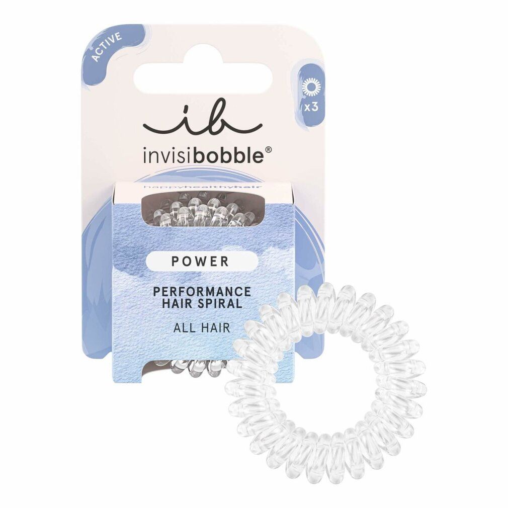 Tre elastici per capelli a spirale trasparenti. Singoli, disposti a cerchio.