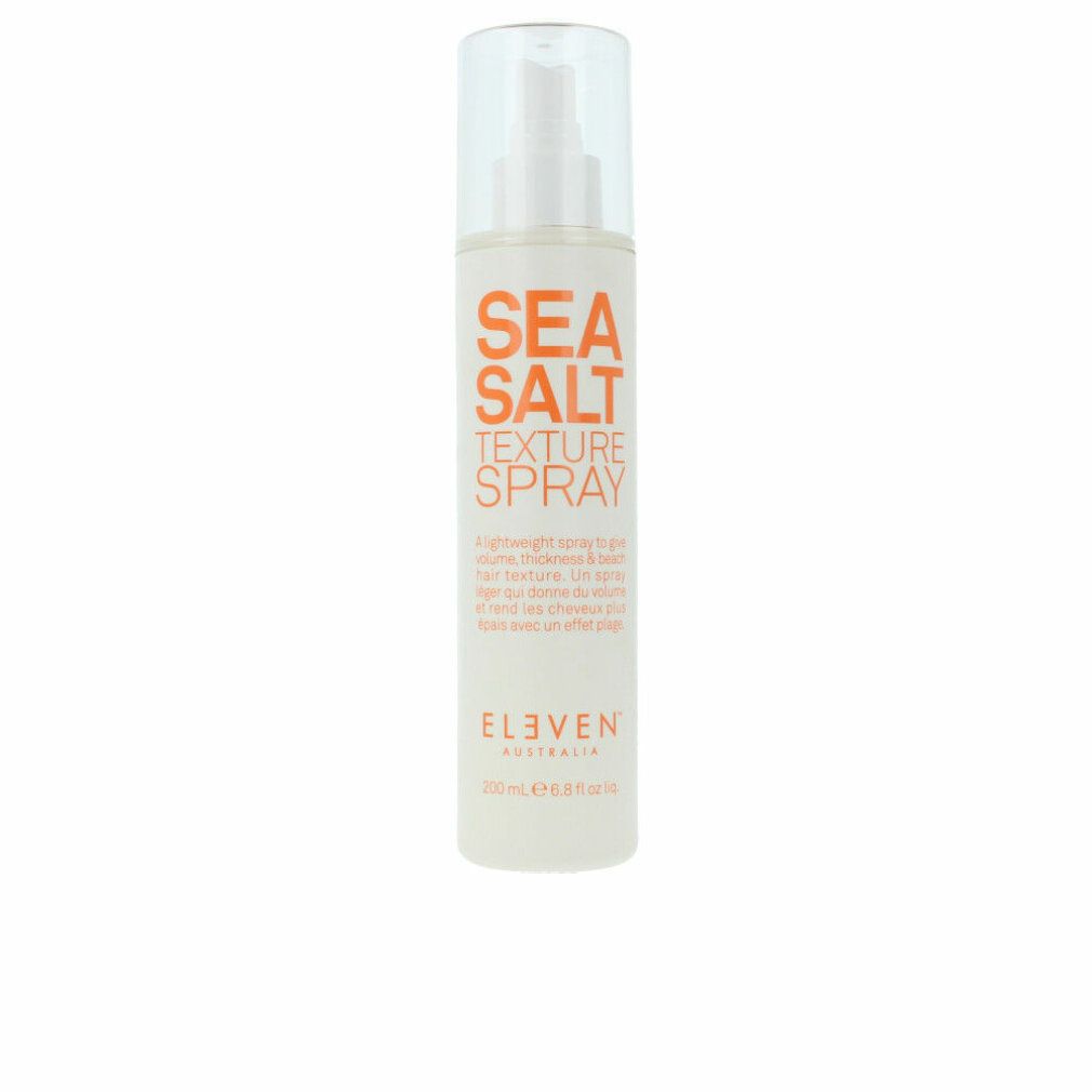 Spray bianco con testo arancione. Scritta: SEA SALT TEXTURE SPRAY. Marchio: ELEVEN. Tappo trasparente.