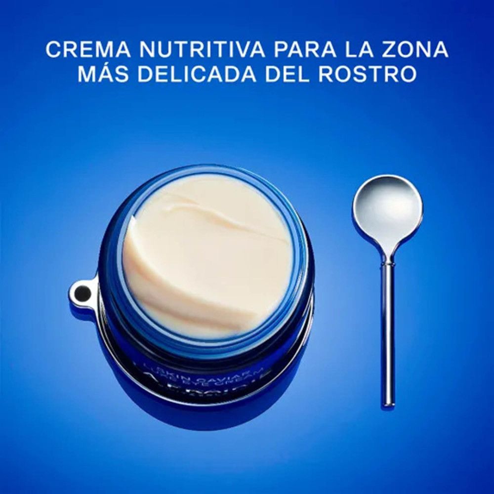 Vasetto blu aperto con crema e spatola. Scritta: Skin Caviar Luxe Eye Cream, La Prairie, Svizzera.