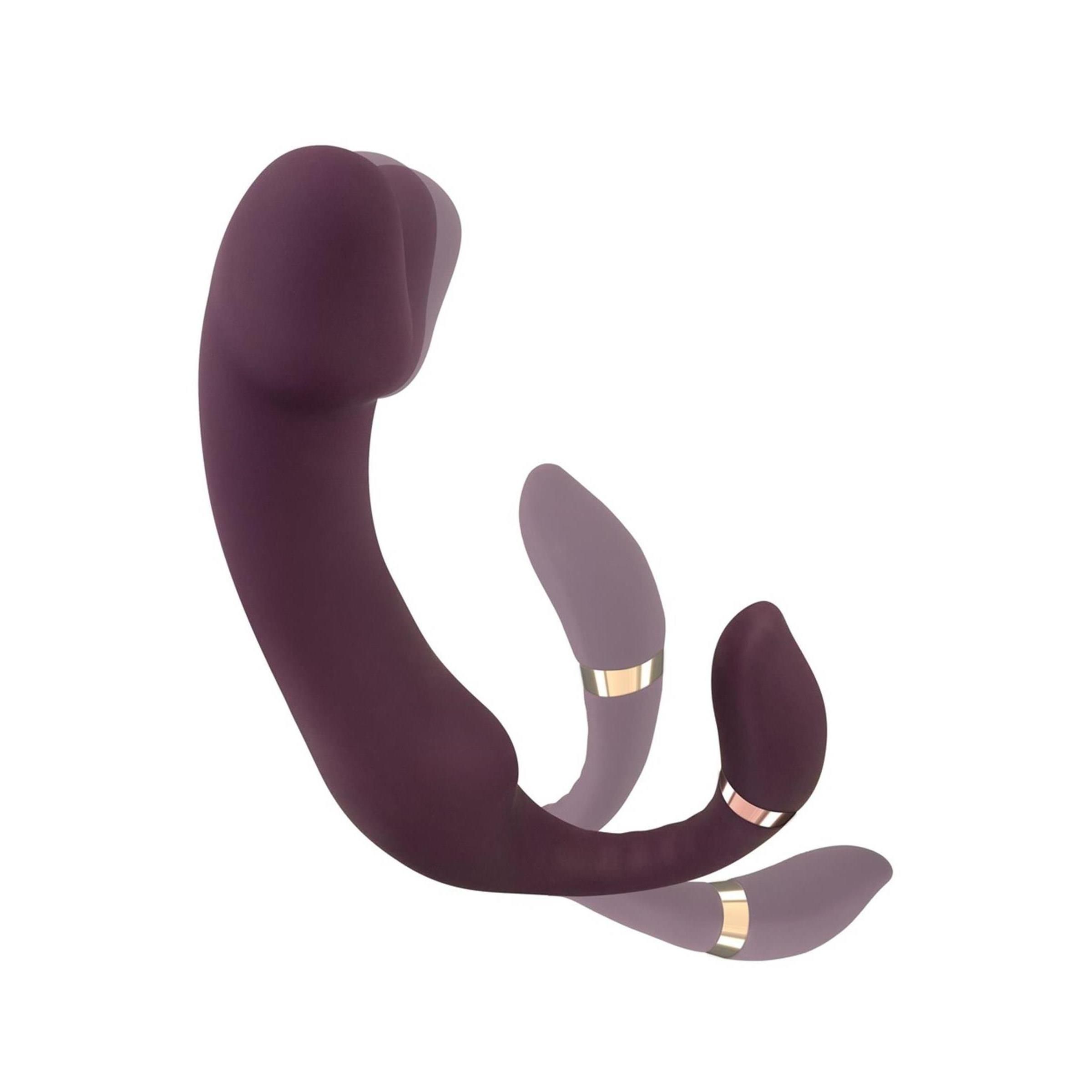 Vibratore viola a forma di U. Con accessorio stimolatore e anello dorato. Su sfondo bianco.
